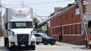 A truck driver was unhurt but trapped in his vehicle Friday after wires came down in Everett, Massachusetts.