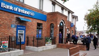 People queue to enter a Bank of Ireland branch in Finglas village, Dublin. Bank of Ireland has apologised after a glitch led to some of its customers withdrawing or transferring more money than was in their accounts. The bank said this was down to a technical issue with its services and not a cyber attack.