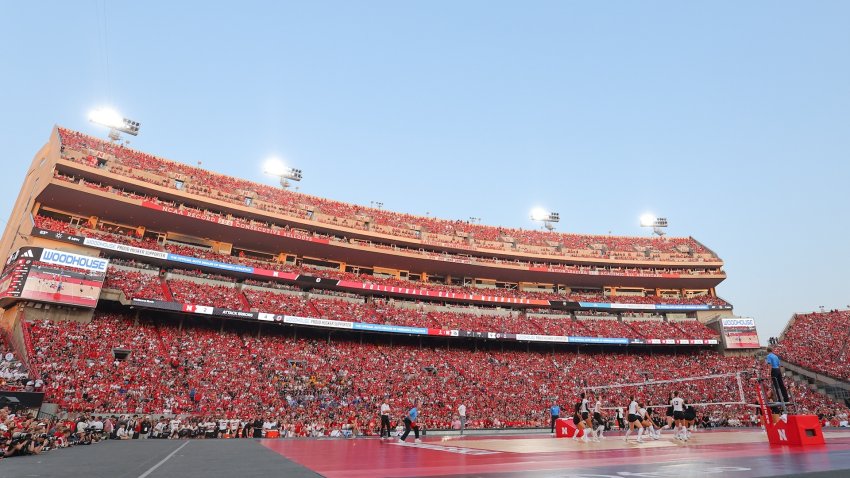 A stadium full of people watching a volleyball match