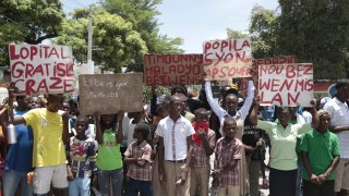 Students from the El Roi academy carry signs during a demonstration to demand the freedom of New Hampshire nurse Alix Dorsainvil and her daughter, who have been reported kidnapped, in the Cite Soleil neighborhood of Port-au-Prince, Haiti, July 31, 2023.