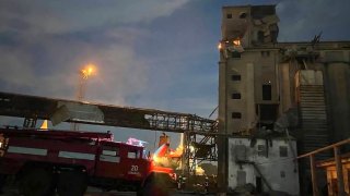 In this photo provided by regional Governor Oleh Kiper rescuers work on a scene of drone attack in Odesa region, Ukraine, early Wednesday, Aug. 2, 2023.