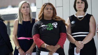 Amanda Zurawski, who developed sepsis and nearly died after being refused an abortion when her water broke at 18 weeks, left, and Samantha Casiano, who was forced to carry a nonviable pregnancy to term and give birth to a baby who died four hours after birth, center, stand with their attorney Molly Duane outside the Travis County Courthouse, Wednesday, July 19, 2023, in Austin, Texas.