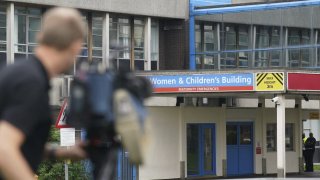 Members of the media outside the Countess of Chester Hospital in Chester, England, Friday, Aug. 18, 2023.