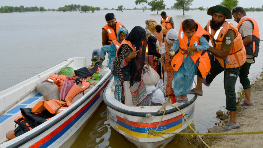 Rescue workers evacuate villagers through a boat from a flooded area of Pakpattan district of Pakistan’s Punjab province, Wednesday, Aug. 23, 2023. Rescuers have evacuated more than 100,000 people from flood-hit areas of Pakistan’s eastern Punjab province in the past three weeks, officials said Wednesday.