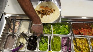 BETHESDA, MD.- SEPTEMBER, 27: Matt Taylor prepares a Buffalo Burrito at Boloco at 4930 Elm Street in Bethesda, Md. 2012.
(Photo by Mary F. Calvert/For The Washington Post via Getty Images)