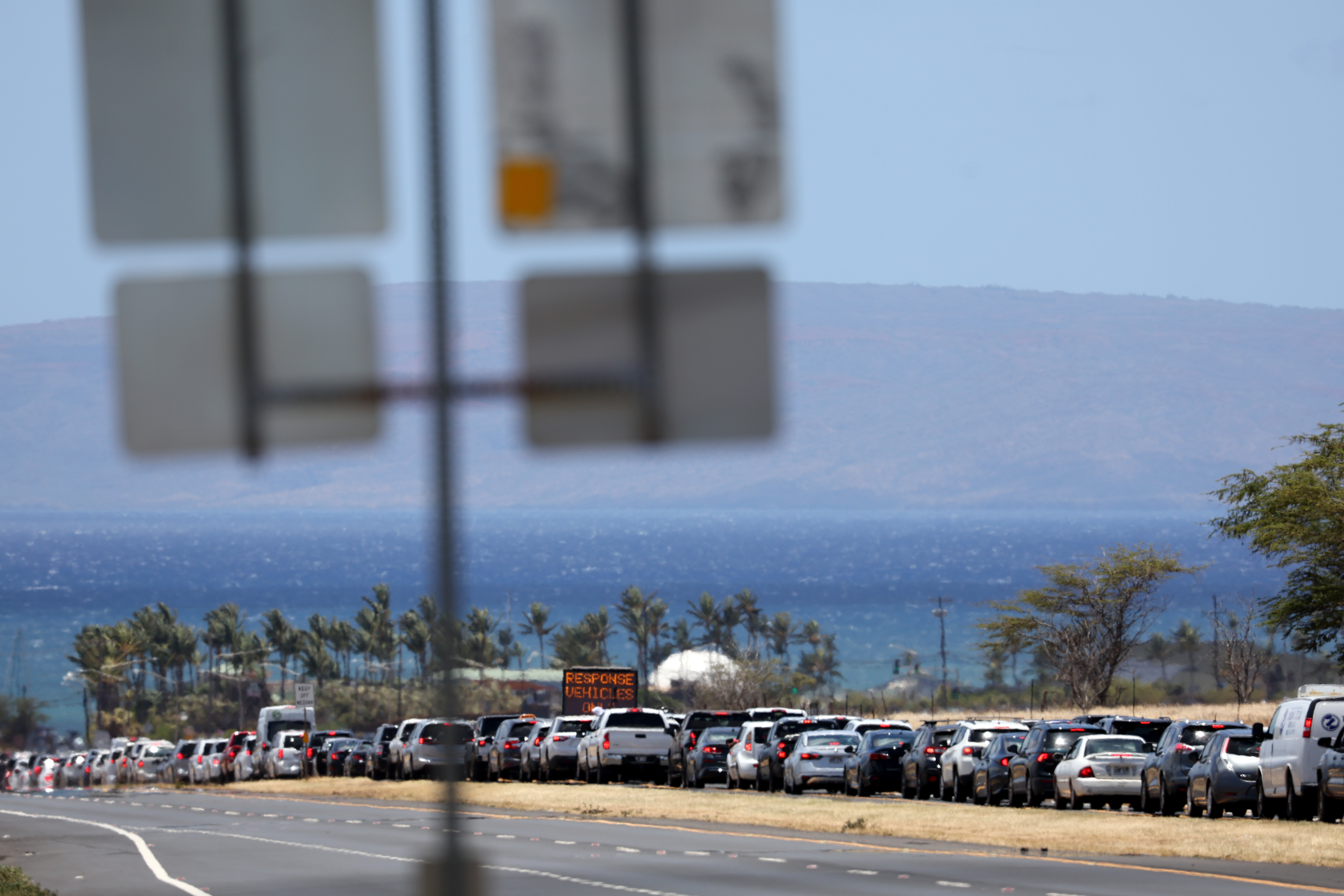 Cars are backed up for miles on the Honoapiilani highway as residents are allowed back into areas affected by the recent wildfire, Aug. 11, 2023, in Wailuku, Hawaii. Dozens of people were killed and thousands were displaced after a wind-driven wildfire devastated the town of Lahaina on Tuesday. Crews are continuing to search for missing people.