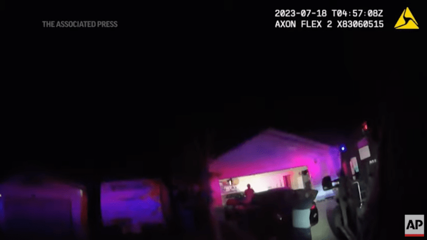 In this Monday evening, July 17, 2023 image taken from police body camera video provided by the Las Vegas Metropolitan Police Department, an unidentified man and woman are seen as SWAT officers raided a home in the nearby city of Henderson, Nev., in connection with the 1997 killing of rapper Tupac Shakur near the Las Vegas Strip.