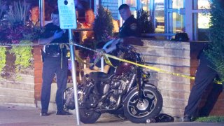 A motorcycle at the scene of a hit-and-run crash in Falmouth, Massachusetts, that officials said Tuesday, Aug. 15, 2023, left a husband and wife hurt.
