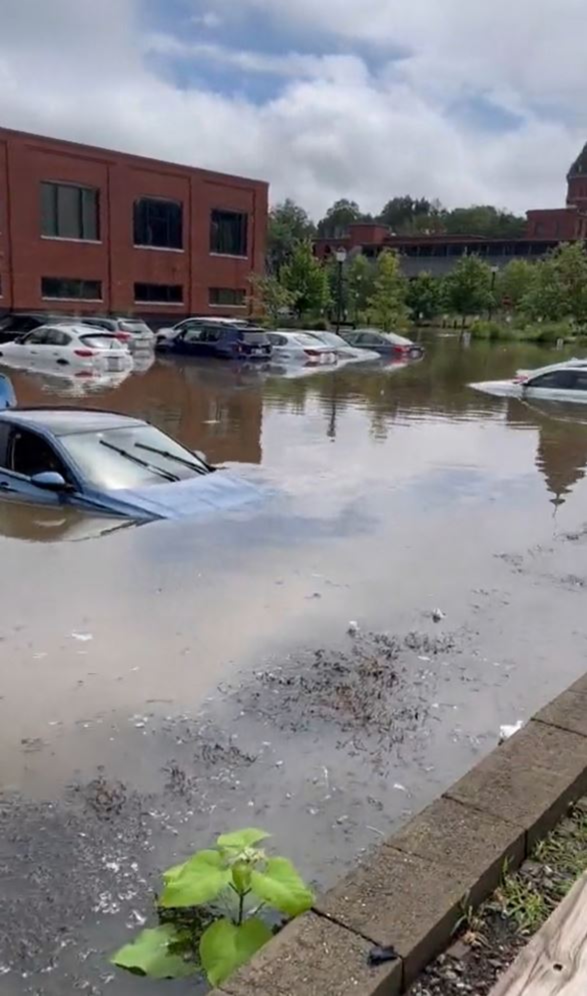 A flooded parking lot on High Street in North Andover, Massachusetts, after storms on Aug. 8, 2023.