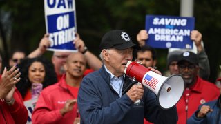 President Joe Biden addresses striking members of the United Auto Workers union at a picket line outside a General Motors Service Parts Operations plant in Belleville, Michigan, on Sept. 26, 2023.