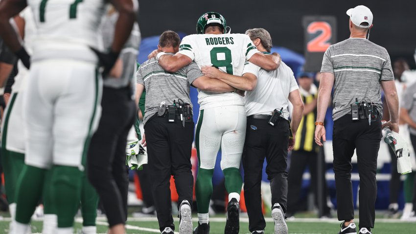 EAST RUTHERFORD, NEW JERSEY – SEPTEMBER 11: Aaron Rodgers #8 of the New York Jets is helped off the field for an apparent injury during a game against the Buffalo Bills at MetLife Stadium on September 11, 2023 in East Rutherford, New Jersey.