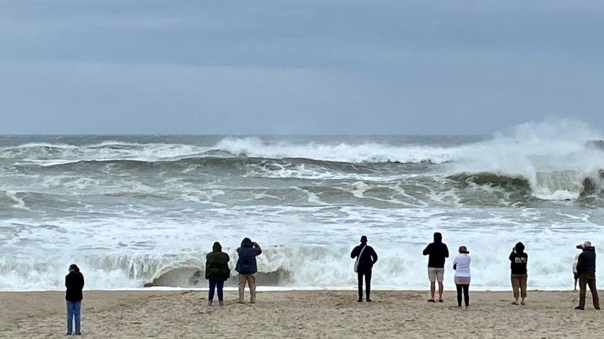 Beachgoers watch the waves on Nauset Beach in Eastham, Massachusetts, two hours before high tide as Lee passes through New England.