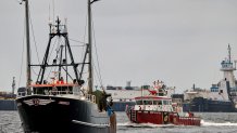 The fishing vessel America bringing a man who crew said they happened upon in the ocean to land in Boston on Tuesday, Sept. 26, 2023.