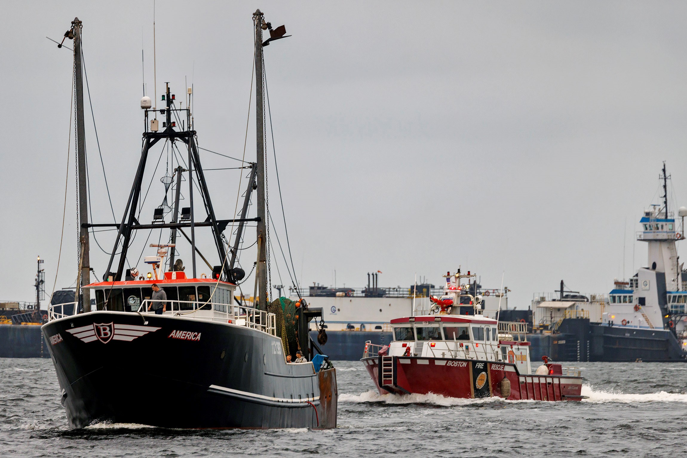 The fishing vessel America bringing a man who crew said they happened upon in the ocean to land in Boston on Tuesday, Sept. 26, 2023.