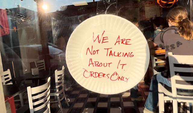 A sign reading, "We are not talking about it, orders only," at Dragon Pizza in Somerville, Massachusetts, on Friday, Sept. 1, 2023.