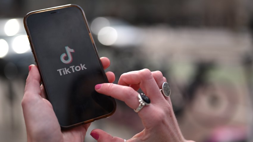 TikTok logo displayed on a cellphone.