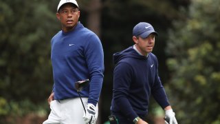 Tiger Woods and Rory McIlroy look on from the 11th tee during a practice round prior to the 2023 Masters Tournament at Augusta National Golf Club in Augusta, Georgia, on April 3, 2023.