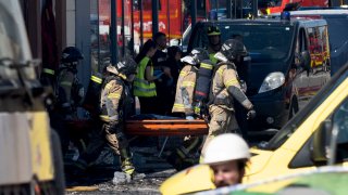 Firefighters carry out a covered body on a stretcher after a fire in a nightclub in Murcia, Spain in the early hours of Sunday Oct. 1, 2023. At least 13 people were killed in a fire in a Spanish nightclub on Sunday morning, authorities said, with fears the toll could still rise as rescue workers sift through the debris.The fire broke out in the two-storey “Teatre” nightclub, also called “Fonda Milagros”, in the city of Murcia in southeastern Spain in early hours of the morning.