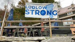 A “Ludlow Strong” sign hangs outside a restaurant, in Ludlow, Vt., Thursday, Oct. 19, 2023, three months after severe flooding hit the ski town. As winter approaches and the fall tourism season lingers, Ludlow businesses who lost out on summer tourism want to get the word out that they are open, even though a handful are still in the throes of rebuilding.