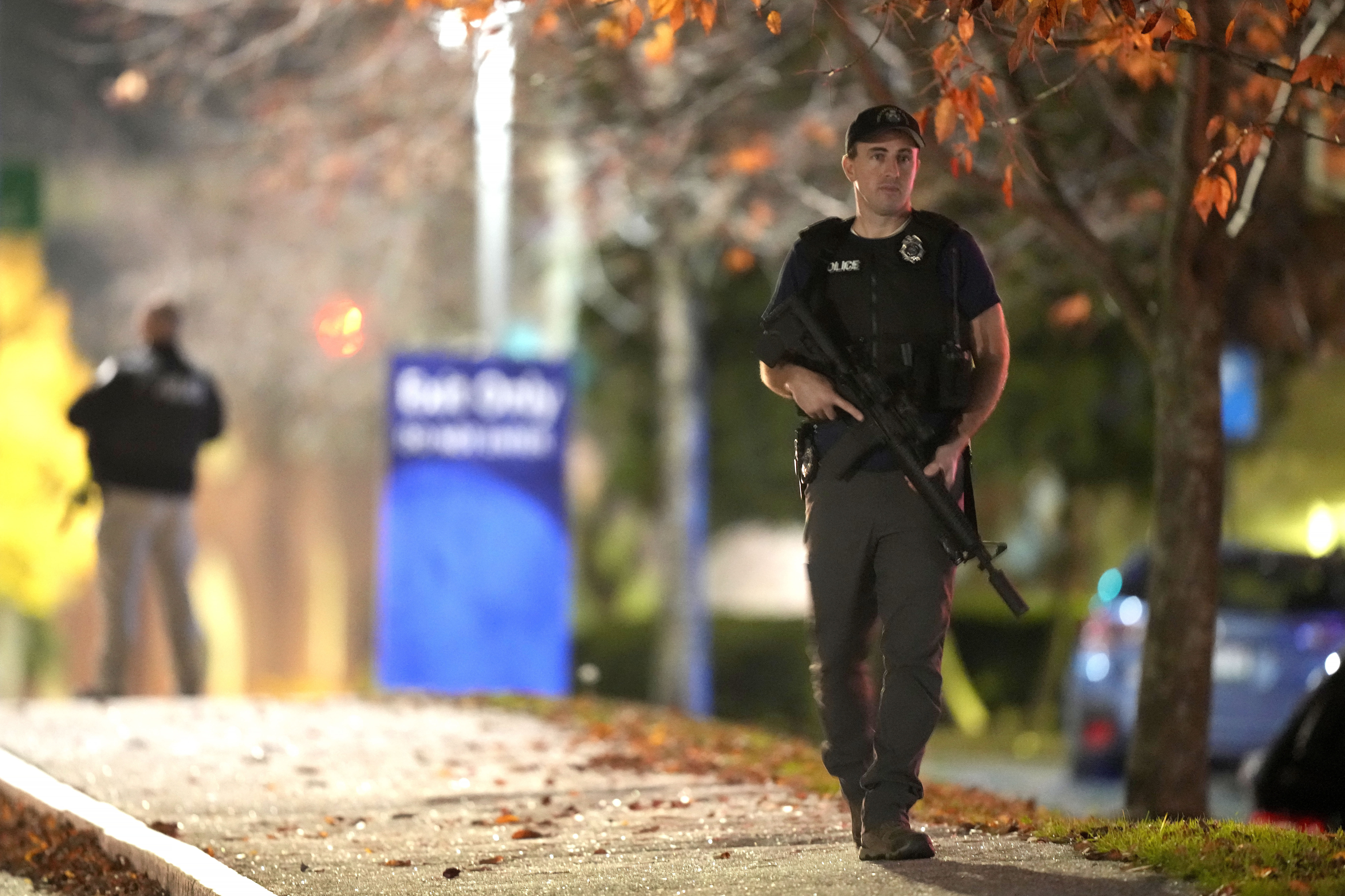 Law enforcement officers carry rifles outside Central Maine Medical Center during an active shooter situation, in Lewiston, Maine, Wednesday, Oct. 25, 2023.