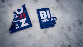 MANCHESTER, NEW HAMPSHIRE – FEBRUARY 11, 2020: On the day of the New Hampshire primary, a discarded Joe Biden campaign sign lie ripped on the snow as Democratic Presidential Candidate Senator Elizabeth Warren greets a crowd of New Hampshire voters  at a polling location in Manchester, New Hampshire on Tuesday February 11, 2020. (Photo by Melina Mara/The Washington Post via Getty Images)