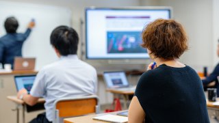 Mid adult woman in a continuing education class at a community college or university in Japan