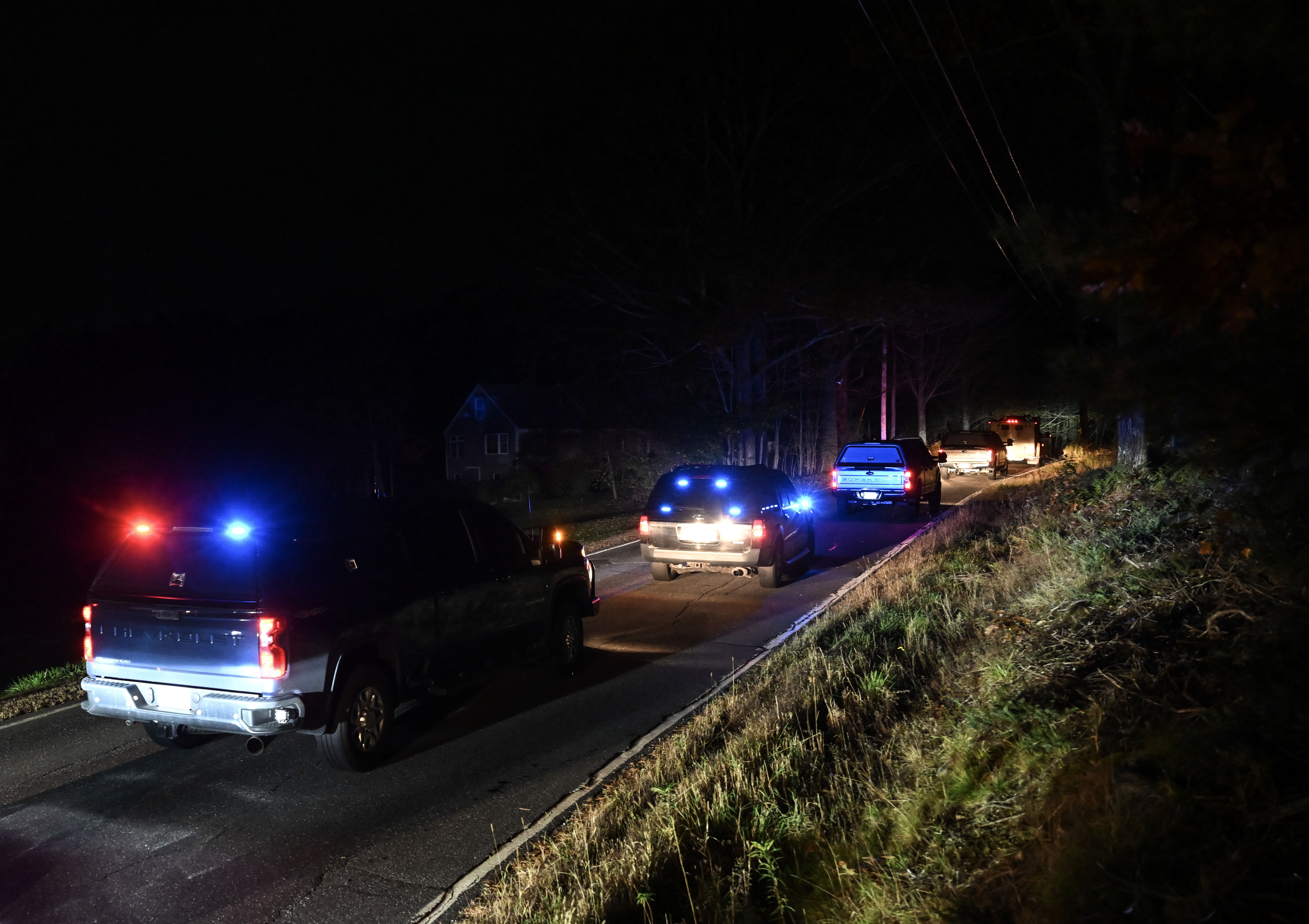 Heavily armed police search the home of suspect Robert Card’s father and brother in Bowdoin, Maine on Thursday, Oct. 26, 2023.