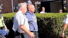 Aidan Kearney, the outspoken blogger known as "Turtleboy," being led into Massachusetts' Stoughton District Court on Wednesday, Oct. 11, 2023.