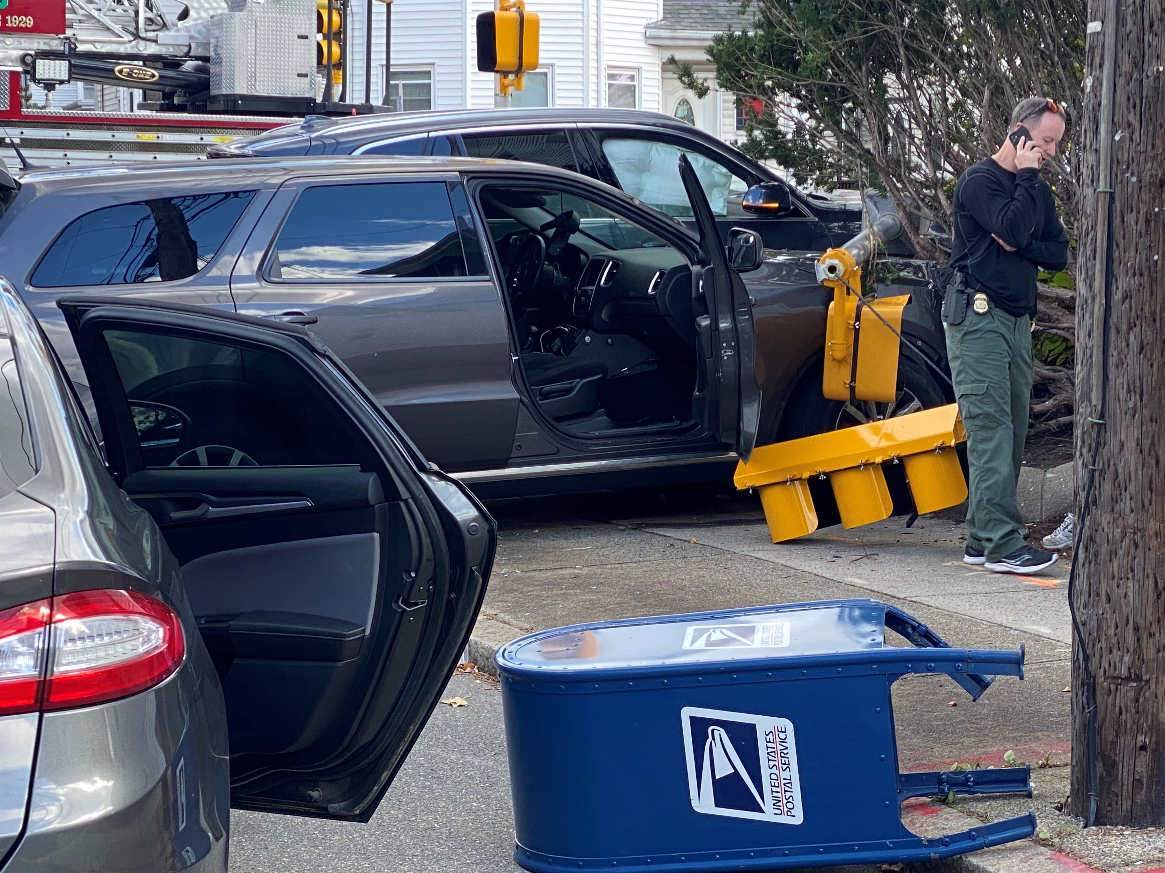 An apparent car crash in Malden, Massachusetts, on Thursday, Oct. 19, 2023, left several vehicles damaged and traffic lights and a mailbox knocked over.