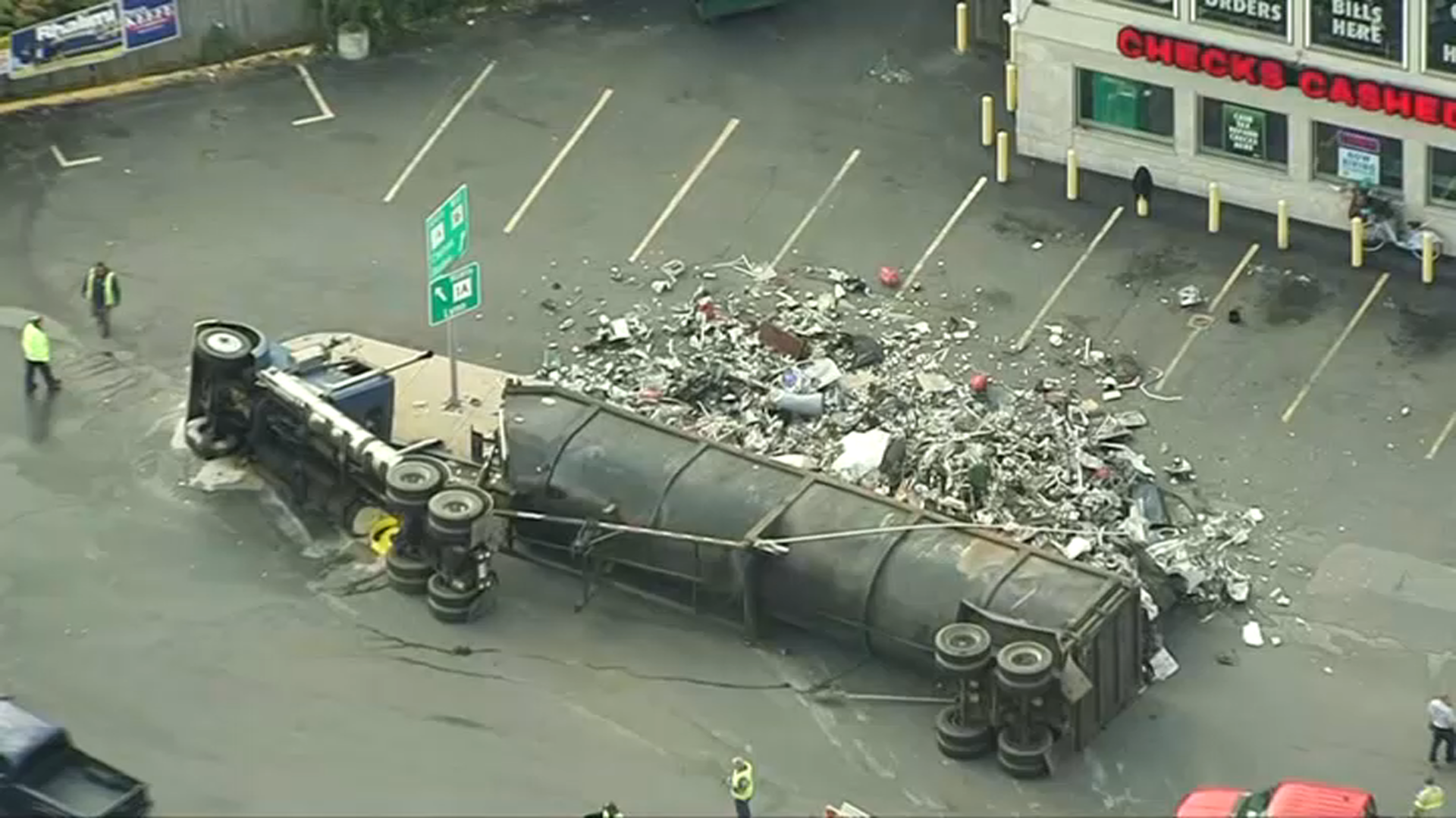 A rolled-over truck that spilled trash or scrap in Revere, Massachusetts, on Tuesday, Oct. 10, 2023.