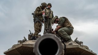 Israeli soldiers pictured on a tank at the Israel-Gaza border.