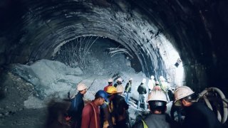 rescuers inside a collapsed road tunnel