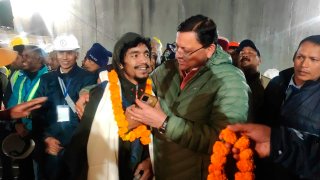 Pushkar Singh Dhami, right, Chief Minister of the state of Uttarakhand, greets a worker rescued from the site of an under-construction road tunnel that collapsed in Silkyara in the northern Indian state of Uttarakhand, India.