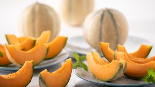 Cantaloup melon slices composition in a luminous kitchen