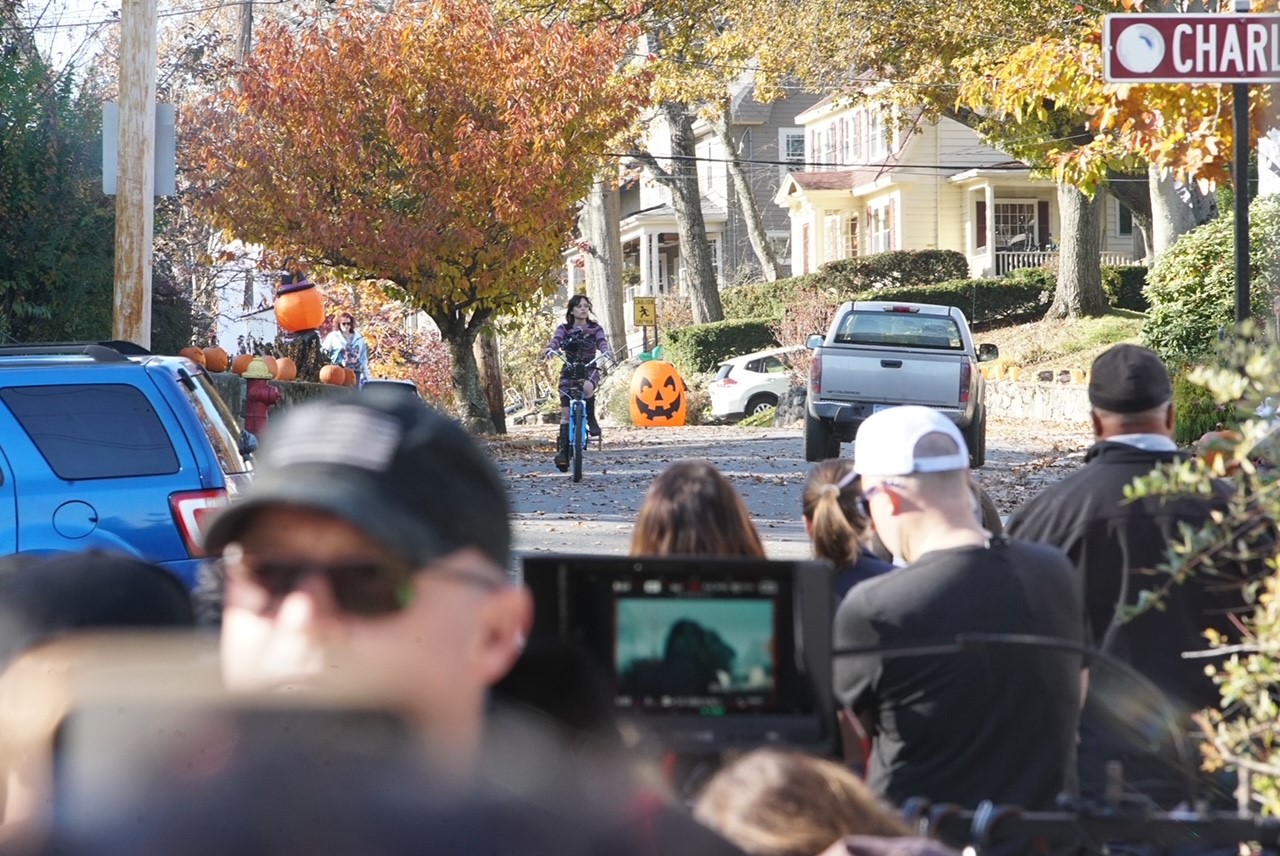 Actress Jenna Ortega on a bicycle while filming "Beetlejuice 2" in Melrose, Massachusetts, on Thursday, Nov. 16, 2023.