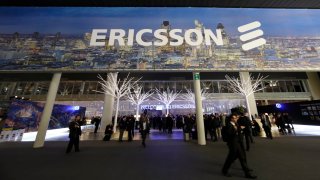 Visitors pass through the entrance to the Ericsson AB pavilion at the Mobile World Congress in Barcelona, Spain, on Tuesday, Feb. 26, 2013.