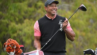 Tiger Woods wipes his driver grip on the 18th tee box during the first round of the PGA TOUR Champions PNC Championship at The Ritz-Carlton Golf Club on December 17, 2022 in Orlando, Florida.