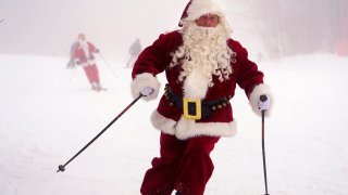 A skier dressed as Santa Claus.