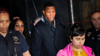 Jonathan Majors, third from left, leaves a courtroom
