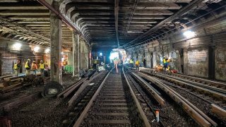 Crews performing track and tunnel work near Arlington Station.