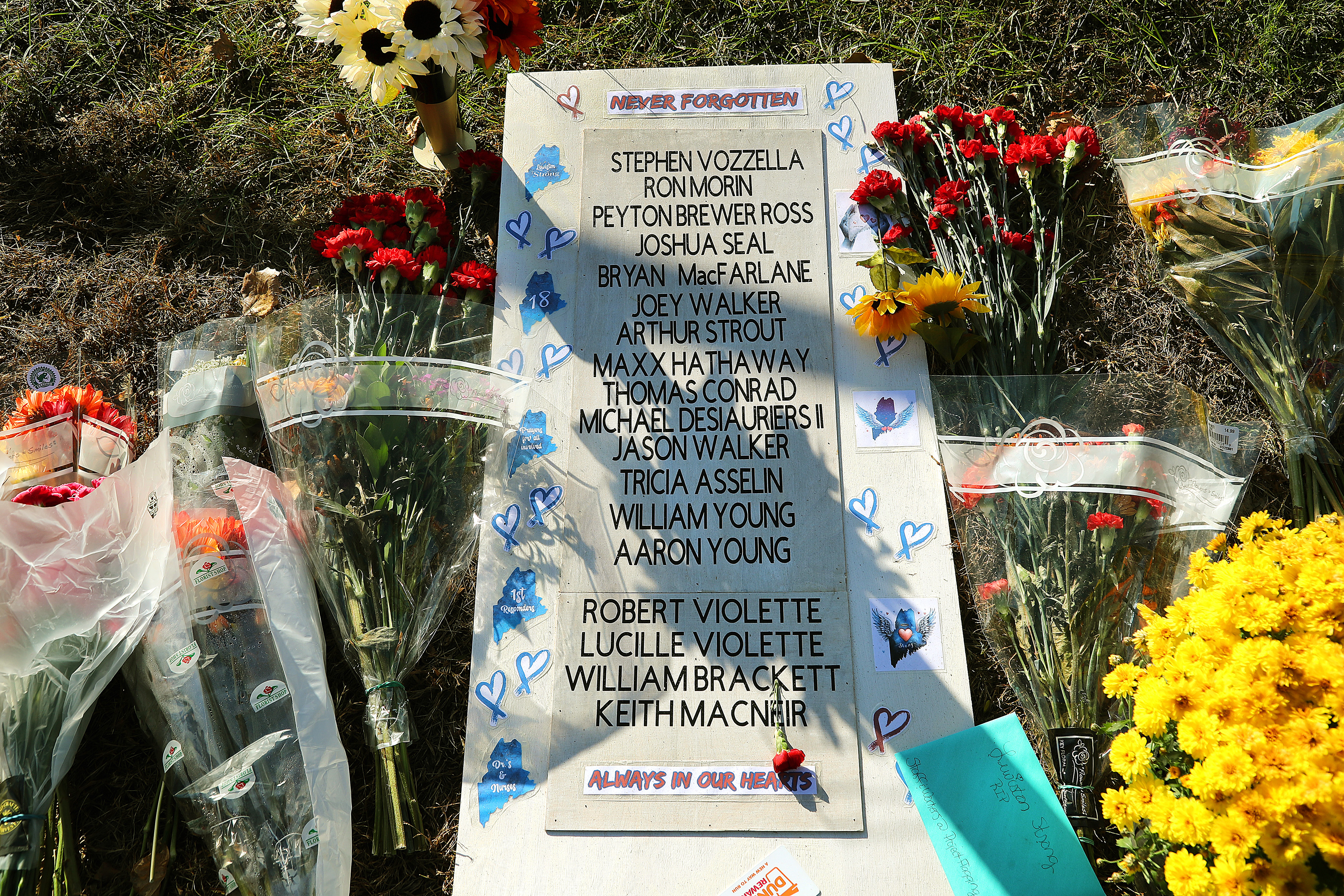 Lewiston, ME – November 3: A poster with the names of those killed in the mass shooting in Lewiston, Maine lies at a makeshift memorial at Schemengees Bar and Grille. (Photo by John Tlumacki/The Boston Globe via Getty Images)