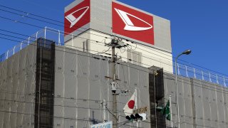 The Daihatsu Motor Co. signage atop its headquarters in Ikeda, Osaka Prefecture, Japan, on Thursday, Dec. 21, 2023. Daihatsu Motor offices were raided by the Japanese government after an inspection scandal forced the Toyota Motor Corp. subsidiary to suspend all car shipments indefinitely.