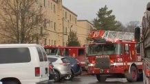 Boston firefighters at the scene of a standoff in the city's Mattapan neighborhood on Saturday, Dec. 30, 2023.