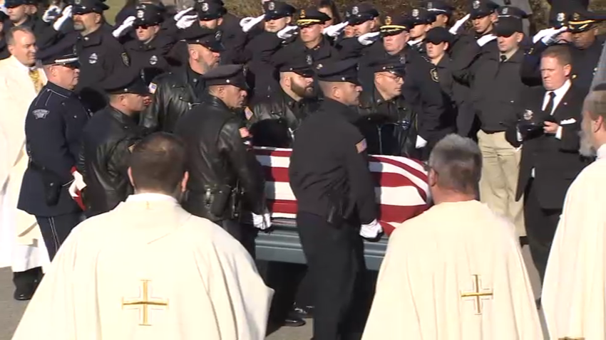 The casket of fallen Waltham, Massachusetts, Police Officer Paul Tracey being escorted from the church where his funeral was held on Friday, Dec. 15, 2023.