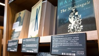 Snippets from online Amazon customer reviews as well as star ratings are displayed for books at one of the original Amazon Books stores opened in Seattle, Washington in 2015. In 2022, Amazon shut down its physical bookstore business.