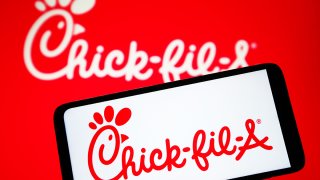 File photo of Chick-fil-A logo on phone and in background