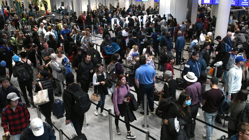 Passengers wait in the Transportation Security Administration (TSA) screening line at Orlando International Airport ahead of the Christmas holiday travel on December 22, 2023 in Orlando, Florida.