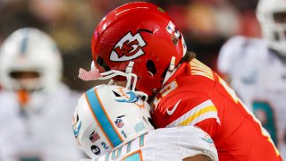 Kansas City Chiefs quarterback Patrick Mahomes (15) helmet cracks taking a hit from Miami Dolphins safety DeShon Elliott (21) playoff game between the Miami Dolphins and Kansas City Chiefs on Jan 13, 2024 at GEHA Field at Arrowhead Stadium in Kansas City, MO.