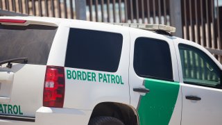 Border patrol car at the US border with Mexico in San Diego with the fence behind.