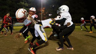 This photo provided by the University of Maryland shows a Maryland Heat youth tackle football team practicing in Fort Washington, Md., Nov. 9, 2023. Some parents are opting to enroll their children in leagues that play flag football, which limits contact on the field. But youth tackle leagues remain popular in many parts of the country.